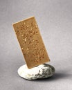 Bar of white chocolate on stone gray background. Side view. Place for text Royalty Free Stock Photo