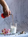 Bar woman pouring mixed tea into a glass of milk Royalty Free Stock Photo