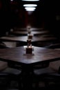 Bar wooden tables in a row, with pepper, salt shaker, toothpicks, wipes