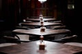 Bar wooden tables in a row, with pepper, salt shaker, toothpicks, wipes