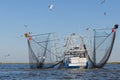 Shrimp boat in Barataria Bay, Louisiana with seagulls and barking dog Royalty Free Stock Photo