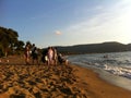 Baratti, Italy on August 16th, 2013. The evening The evening beach and sea at sunset. on the shore rest tourists