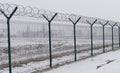 Barb wire fence at the cold winter day Royalty Free Stock Photo