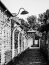 Barb wire fence with guard lamps and tower in concentration camp, Auschwitz, or Oswiecim, Poland