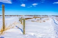 A barb wire fence in a snow covered field Royalty Free Stock Photo