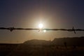 Barb wire strand with sunset in background Royalty Free Stock Photo