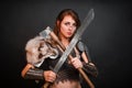 Barbarian woman warrior in chainmail armor with bracers, armor shoulder pad, polar fox fur on her shoulders Royalty Free Stock Photo