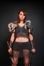 Barbarian woman warrior in chainmail armor with bracers, armor shoulder pad, polar fox fur on her shoulders