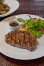 Barbecue Beef Steaks medium rare with grilled potaoes and vegetables Royalty Free Stock Photo