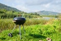 Barbecue, charcoal grill on the river bank. Relaxation, cooking in the fresh air. Summer rest.