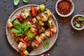 Barbecue of chicken on skewers with vegetables. Picnic