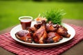 barbecue chicken with tangy sauce on a grass background