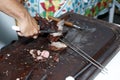 Detail of waiter slicing barbecue Royalty Free Stock Photo