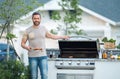 Barbecue concept. Middle aged hispanic man in t-shirt for barbecue. Roasting and grilling food. Roasting meat outdoors Royalty Free Stock Photo