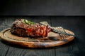 Barbecue Dry aged Ribeye Steak with knife and fork on cutting board Royalty Free Stock Photo