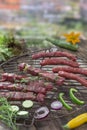 Barbecue food meat, and beef skewer of beef basil, marguez,tarragon on grill on woden table over aols blury wall Royalty Free Stock Photo