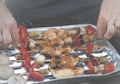 Barbecue in the garden, you can see skewers, chicken and mushrooms and peppers. Metal sheet over heated coals. Royalty Free Stock Photo