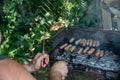 Barbecue Grill in backyard of country side, preparing, grilling sausages and green peppers Royalty Free Stock Photo