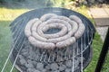 Barbecue grill bbq on coal charcoal grill with raw bratwurst sausages meat delicious summer meal Royalty Free Stock Photo