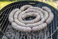 Barbecue grill bbq on coal charcoal grill with raw bratwurst sausages meat delicious summer meal Royalty Free Stock Photo