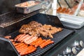 Barbecue grill bbq on propane gas grill steaks bratwurst sausages meat meal Royalty Free Stock Photo