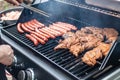 Barbecue grill bbq on propane gas grill steaks bratwurst sausages meat meal Royalty Free Stock Photo