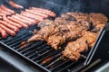 Barbecue grill bbq on propane gas grill steaks bratwurst sausages meat meal Royalty Free Stock Photo