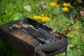 Barbecue grill with glowing coals. Dirty Charcoal Grill on garden background. outddors Royalty Free Stock Photo