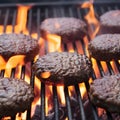 Barbecue grill with hamburger patties cooking over glowing embers