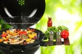 Barbecue grill with meat products and vegetables on blurred background, closeup Royalty Free Stock Photo