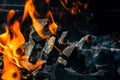 Barbecue grill pit with glowing and flaming hot open fire with red flame, hot charcoal briquettes and embers Royalty Free Stock Photo