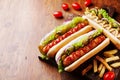 Barbecue grilled hot dog with sausage and yellow mustard with ketchup on wooden board. Traditional american fast food. Royalty Free Stock Photo