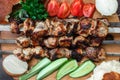 Grilled meat skewers, shish kebab, healthy vegetable fresh tomato, cucumber, onion and bread, top view Royalty Free Stock Photo