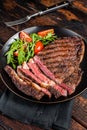 Barbecue grilled and sliced wagyu Rib Eye beef meat steak on a plate. Dark background. Top view Royalty Free Stock Photo