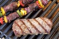 Barbecue. Grilled steak, shish kebab and grilled peppers, onion, on hot grill Royalty Free Stock Photo
