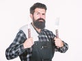 Barbecue master. Bearded hipster wear apron for barbecue. Roasting and grilling food. Man hold cooking utensils barbecue Royalty Free Stock Photo