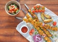 Barbecue meat. Chicken kebab. Chicken Shashlik with vegetables on wooden background. Royalty Free Stock Photo