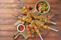 Barbecue meat. Chicken kebab. Chicken Shashlik with vegetables on wooden background. Royalty Free Stock Photo