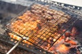 Barbecue meat cooking on fire - the ingredient of bun cha the famous Vietnamese noodle soup with bbq meat, spring roll, vermicelli Royalty Free Stock Photo