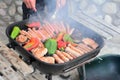 Barbecue with meat, sausages and peppers cooking on fire Royalty Free Stock Photo