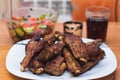 Barbecue pork ribs and vegetables on white plate, close up view Royalty Free Stock Photo