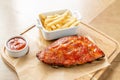 Barbecue pork spare rib. Grilled pork baby ribs with spicy bbq sauce served with french fries. Royalty Free Stock Photo