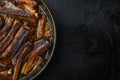 Barbecue pork spare ribs, in frying cast iron pan, on black stone background, top view flat lay, with copy space for text Royalty Free Stock Photo