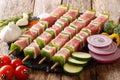 For barbecue raw shish kebab with pepper and lard on skewers close-up and ingredients, vegetables, spices, herbs. horizontal Royalty Free Stock Photo