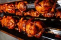 Barbecue roast Chicken in a row turning at industrial roaster Royalty Free Stock Photo