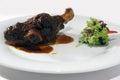 Barbecue , roasted ram bone on a white plate with sauce and fresh parsley. Royalty Free Stock Photo