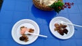 Barbecue with sauce in a plastic disposable dish on a blue plastic table Royalty Free Stock Photo