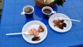 Barbecue with sauce in a plastic disposable dish on a blue plastic table Royalty Free Stock Photo