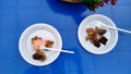 Barbecue with sauce in a plastic disposable dish on a blue plastic table Royalty Free Stock Photo