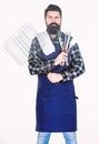 Barbecue season. Bearded hipster wear apron for barbecue. Roasting and grilling food. Man hold cooking utensils barbecue Royalty Free Stock Photo